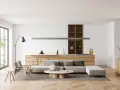 Interni luminosi con divano, tavolino e cucina a vista. Un esempio di come arredare case moderne con stile e funzionalità.