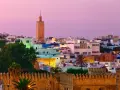 Zachód słońca nad Rabatem, Maroko. Informacje o architekturze i krajobrazie miasta z minaretem w tle.