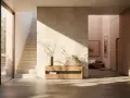 Ingresso moderno con pareti dipinte particolari, scala in pietra e arredi minimalisti. La luce solare crea giochi d'ombra suggestivi.