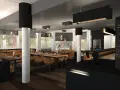 Modernes Fischrestaurant in Berlin mit Holzböden, braunen Ledersitzen und großen Fenstern.