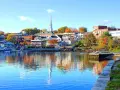 A charming New England harbor town with colorful autumn foliage, perfect for weekend getaways.