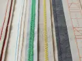 Bandes de tissus aux coutures variées : rouge, bleu, vert, jaune, violet et orange. Un aperçu de techniques de ruban couture.