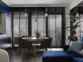 Elegancka kuchnia z szafkami w kolorze granat i drewnianymi elementami. W jadalni okrągły stół z krzesłami, a obok wygodna kanapa.