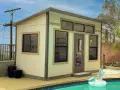 A modern shed, perfect to build a backyard oasis, sits by a pool with a unicorn float.