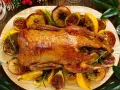 Soczysta kaczka pieczona w całości, podana z jabłkami, figami i pomarańczami. Idealna na świąteczny stół.