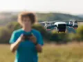 A person controls a drone, unaware of the potential penalty for flying a drone without a license.