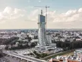 Wielka, kręcona wieża góruje nad miastem. To najwyższy budynek mieszkalny w Polsce, wciąż w budowie, z dźwigiem na szczycie.