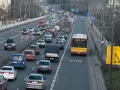 Autobus jedzie pasem dla autobusów. Wokół ruch samochodowy.