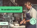 Kucharz w fartuchu przygotowuje jedzenie w kuchni. Czy zastanawiałeś się, ile zarabia kucharz?