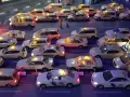 Modellautos von Taxis stehen im Stau. Die Lichter leuchten, als ob sie Nachtzuschlag berechnen würden.