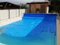 Cubierta azul para piscina, ideal para saber como calentar el agua de la piscina y mantenerla limpia.