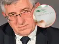 Mężczyzna w okularach trzyma dokument ZUS. Zastanawia się, ile można dorobić do emerytury, by nie stracić świadczeń.