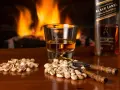 Przy kominku, kieliszek Johnnie Walker i pistacje. Idealny wieczór, czy whisky się chłodzi?