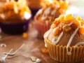 Słodkie muffinki czekoladowe kontra babeczki z nadzieniem, ozdobione lukrem i owocami.