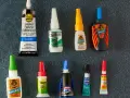 A collection of super glue bottles, including Gorilla Glue and Krazy Glue, are laid out for a comparison of bondic vs super glue.