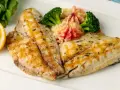 Delicioso gallo a la plancha con puré de patatas rosado, brócoli y rodaja de limón.