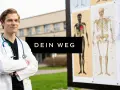 Junger Mann im Arztkittel mit Stethoskop vor anatomischen Tafeln. Sein Weg zum hochschul abschluss beginnt hier.