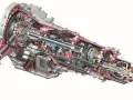 Przekrój skrzyni S tronic z widocznymi kołami zębatymi, wałkami i elementami hydraulicznymi.