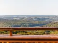 Widok z wieżycy na górzysty krajobraz z lasami i jeziorami.