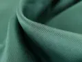 Gładka, zielona tkanina lyocell, przyjemna w dotyku. Dowiedz się, lyocell co to za materiał i dlaczego jest tak ceniony.
