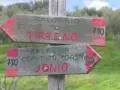 Cartelli in legno indicano il percorso "Kalabria Coast to Coast": uno punta a Tirreno, l'altro a Jonio.