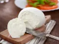 Świeża mozzarella na desce, gotowa do sałatki. Czy mozzarella jest wegetariańska? Tak, tradycyjnie tak!