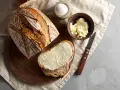 Pyszny chleb na drożdżach, świeżo pokrojony, z masłem i solą. Idealny na śniadanie.