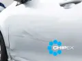 Scratches on a silver car door, with a CHIPEX logo. Can you buff out scratches like these?