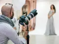 Fotograf z aparatem przygotowuje sesję. Zastanawiasz się, ile kosztuje fotograf na 18. urodziny?
