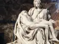 Pieta Michała Anioła: Matka Boska trzyma na kolanach martwe ciało Jezusa. Marmurowa rzeźba zachwyca realizmem i emocjami.
