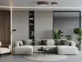 Un ampio divano modulare, perfetto per un soggiorno open space, con poltrona, libreria e piante.