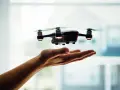 A drone hovers over an open hand, a visual metaphor for understanding Pennsylvania drone laws before takeoff.