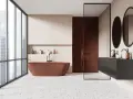 Salle de bain moderne avec baignoire rouille, douche en briques rouges et lavabo suspendu. Le sol en terrazzo offre une belle dimension carrelage.