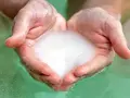 Hands cupped, holding foamy water, ready for a relaxing magnesium foot soak.