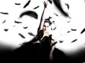 La ballerina Nina, protagonista della trama del film Il Cigno Nero, emerge tra piume nere fluttuanti, simbolo della sua trasformazione.