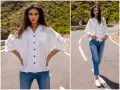 Modelka prezentuje, jak nosić koszulę damską do spodni. Biała, luźna koszula i jeansy tworzą stylowy, casualowy look.