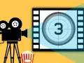 Kamera filmowa, popcorn i plansza z cyfrą 3 – idealne na wieczór z filmami o fotografii.