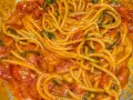 Spaghetti avvolti in un sugo cremoso di pomodoro e basilico, un invitante piatto di pasta allo scarpariello.
