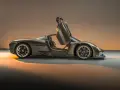 Porsche 918 Spyder z otwartymi drzwiami, widok z boku, w brązowym kolorze.