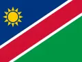 Flaga Namibii z żółtym słońcem. Marzysz o podróży? Sprawdź, czy potrzebna jest namibia wiza.