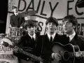 Les Beatles, le groupe le plus connu au monde, jouent sur scène. John Lennon et Paul McCartney chantent, George Harrison joue de la basse, Ringo Starr est à la batterie.
