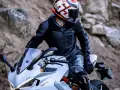 Motociclista con equipo completo, mostrando cómo debe quedar un casco de moto.