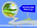 Droga prowadząca do zielonego krajobrazu pod znakiem "Bezpieczne wakacje".