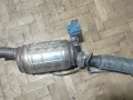 Filtr DPF z Renault Laguna 3 2.0 dCi na drewnianej podłodze.