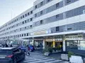 Ingresso Autorimessa Comunale a Piazzale Roma, Venezia. Un'ambulanza e auto parcheggiate.