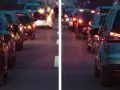 Traffico serale con luci sfocate, come vede le luci un miope. Le auto ferme creano un effetto di aloni luminosi.