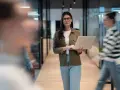 Femme avec un ordinateur portable dans un bureau moderne, préparant une annonce légale changement de gérant.