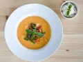 Aksamitny, pomarańczowy **thai red curry** z kawałkami kurczaka, cukinii, pomidorków i bazylii, podany z ryżem.