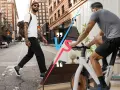 Man walking on city street vs man riding a stationary bike.