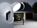 Arlo-kameran med lokal lagring lyser upp en uppfart där en kvinna närmar sig garaget med en bil.